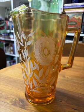 Jeanette glass marigold carnival glass pitcher with cosmos floral pattern